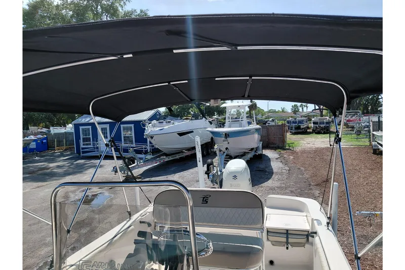 Slide: The Image of 2021 Carolina Skiff 21 LS boat with canopy, parked in a marina. - 38