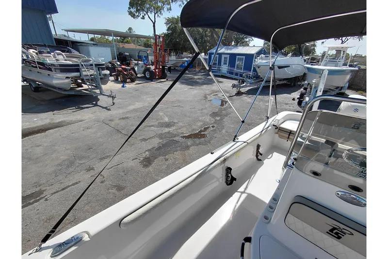 Slide: The Image of 2021 Carolina Skiff 21 LS boat interior with canopy, parked in a marina. - 39