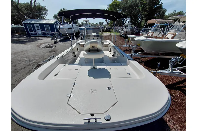 Slide: The Image of 2021 Carolina Skiff 21 LS boat with canopy, parked outdoors in a marina. - 40