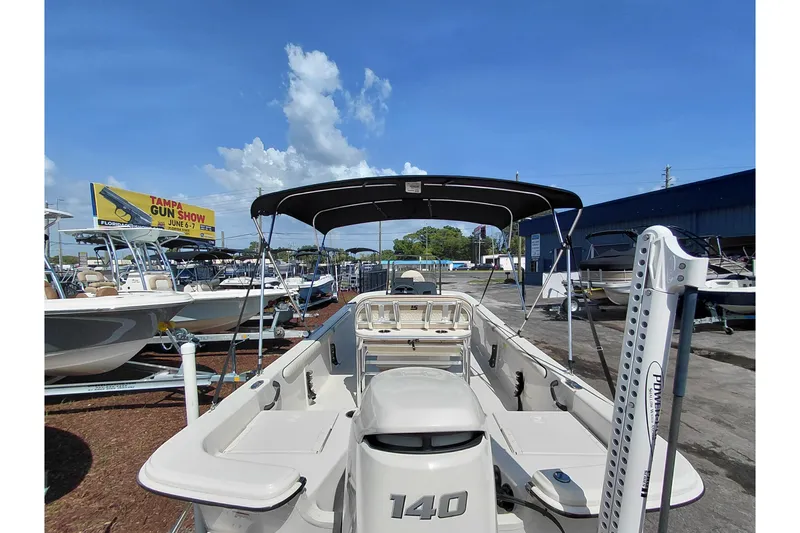 Slide: The Image of 2021 Carolina Skiff 21 LS boat with canopy, displayed outdoors under clear sky. - 41