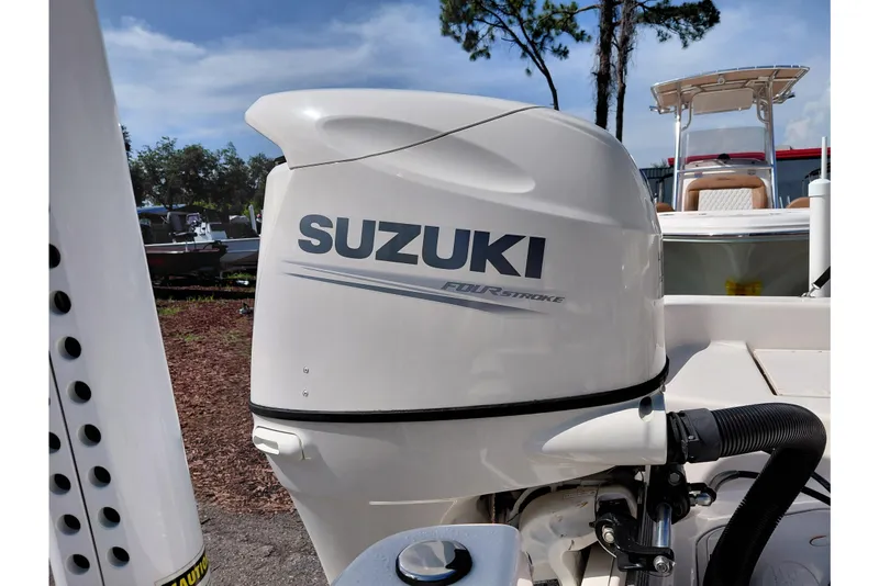 Slide: The Image of Suzuki four-stroke engine on a 2021 Carolina Skiff 21 LS boat, outdoors. - 44