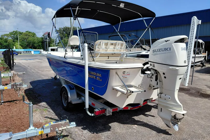 Slide: The Image of 2021 Carolina Skiff 21 LS boat with Suzuki 140 outboard motor on trailer. - 5