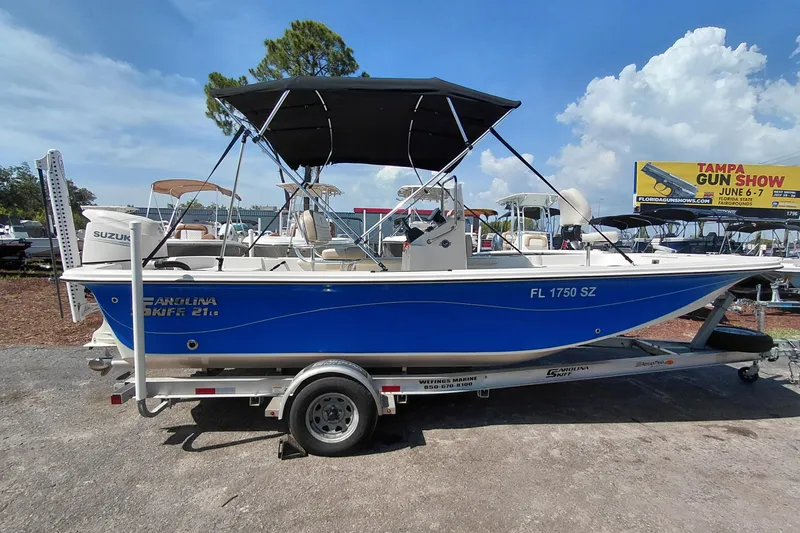 Slide: The Image of 2021 Carolina Skiff 21 LS boat on trailer, blue hull, Suzuki engine, outdoor display. - 8