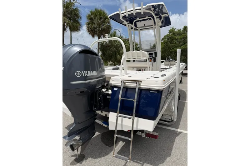 Slide: The Image of 2015 Robalo 246 Cayman boat with Yamaha outboard motor, parked outdoors. - 10