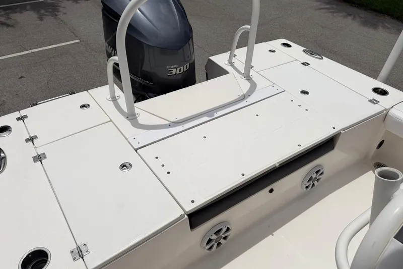 Slide: The Image of 2015 Robalo 246 Cayman boat deck with Yamaha 300 engine, featuring storage compartments. - 12