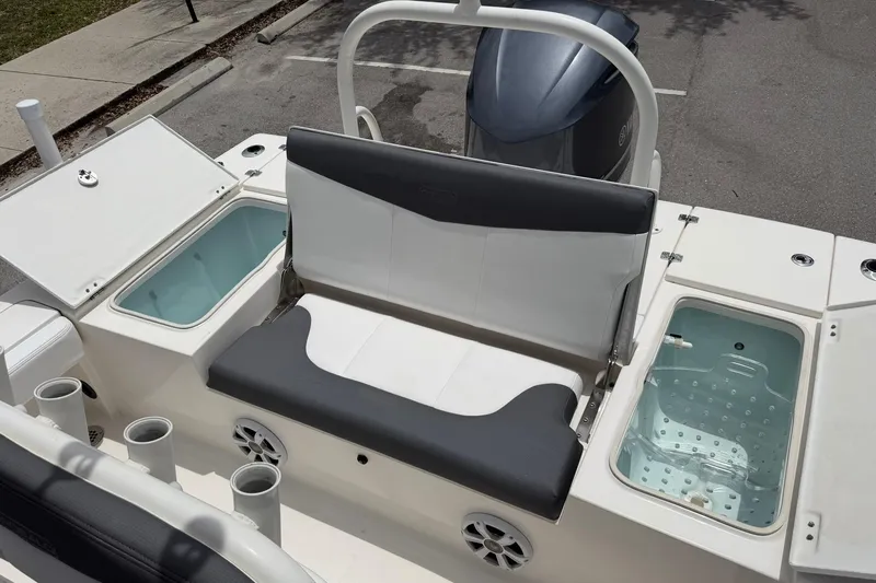 Slide: The Image of 2015 Robalo 246 Cayman boat interior with seating and storage compartments. - 13