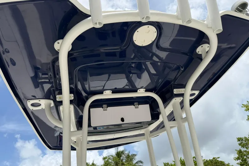 Slide: The Image of 2015 Robalo 246 Cayman boat T-top structure against a cloudy sky. - 15
