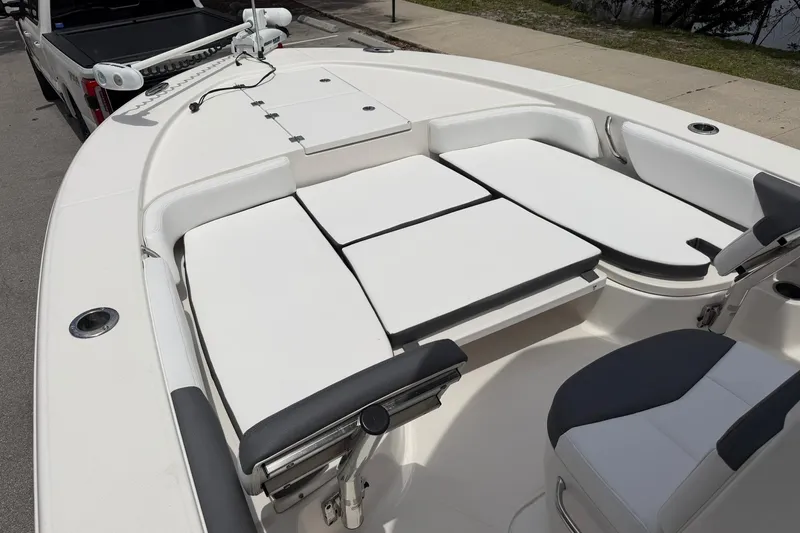 Slide: The Image of 2015 Robalo 246 Cayman boat interior with cushioned seating and fishing rod holders. - 18
