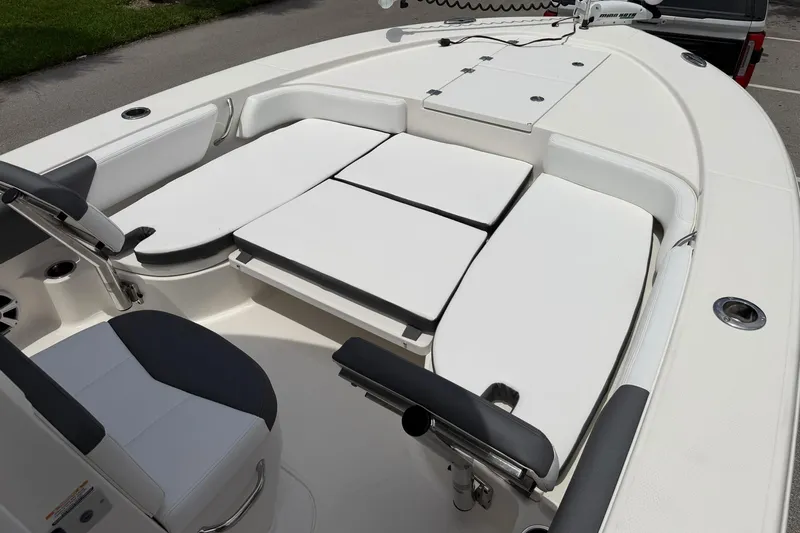 Slide: The Image of 2015 Robalo 246 Cayman boat interior with cushioned seating and storage compartments. - 19