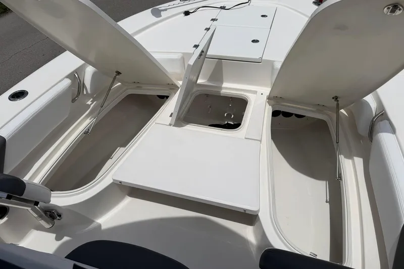 Slide: The Image of 2015 Robalo 246 Cayman boat interior with open storage compartments. - 20