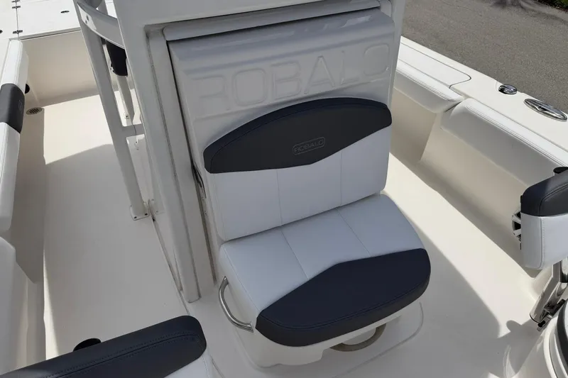 Slide: The Image of 2015 Robalo 246 Cayman boat seat with white and black upholstery. - 24