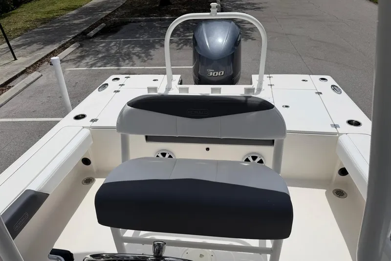 Slide: The Image of 2015 Robalo 246 Cayman boat interior with Yamaha 300 engine in a parking area. - 26