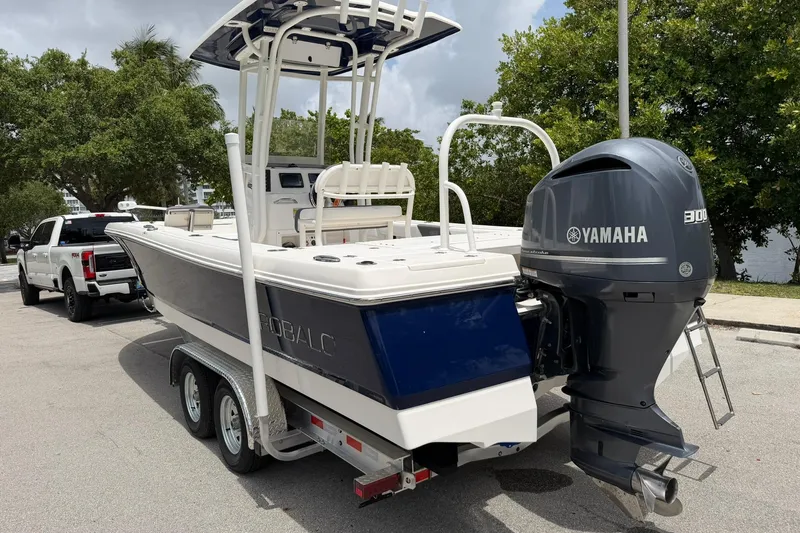 Slide: The Image of 2015 Robalo 246 Cayman boat with Yamaha 300 engine on trailer, parked outdoors. - 5
