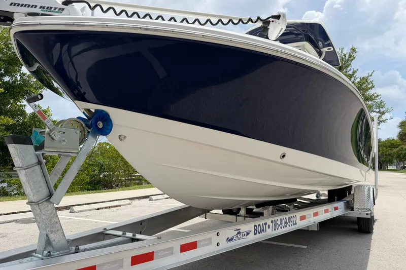 Slide: The Image of 2015 Robalo 246 Cayman boat on trailer, side view, outdoors. - 8