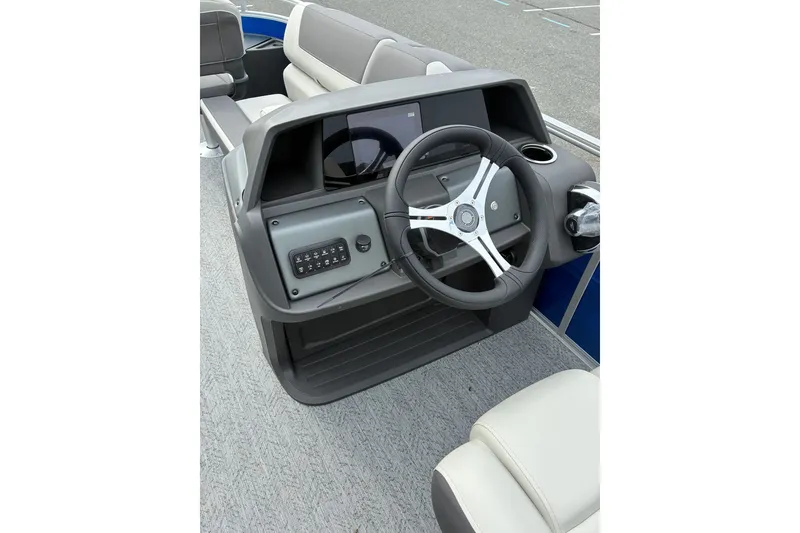 Slide: The Image of 2026 Sun Tracker Fishin' Barge 20 DLX steering console with modern controls and seating. - 14