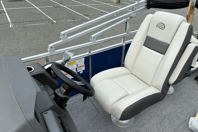 Slide: The Image of 2026 Sun Tracker Fishin' Barge 20 DLX boat interior with steering wheel and comfortable seating. - 13