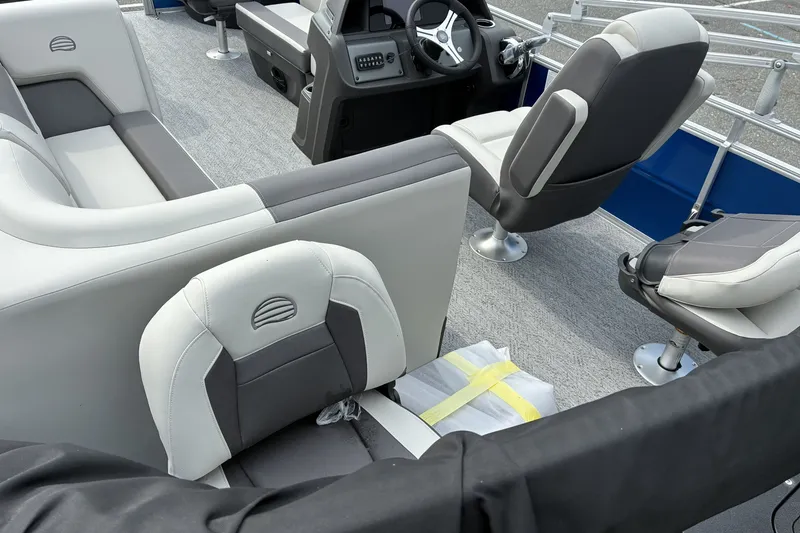 Slide: The Image of 2026 Sun Tracker Fishin' Barge 20 DLX interior with modern seating and steering console. - 17