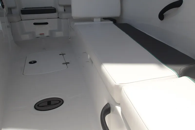 Slide: The Image of Interior view of 2026 Tahoe T18 boat, featuring white seating and storage compartments. - 11