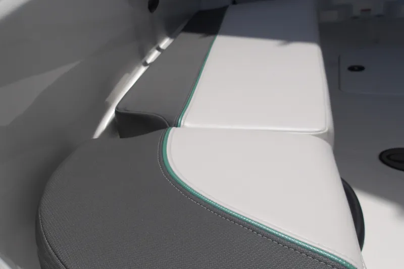 Slide: The Image of 2026 Tahoe T18 boat interior with gray and white cushioned seating. - 12