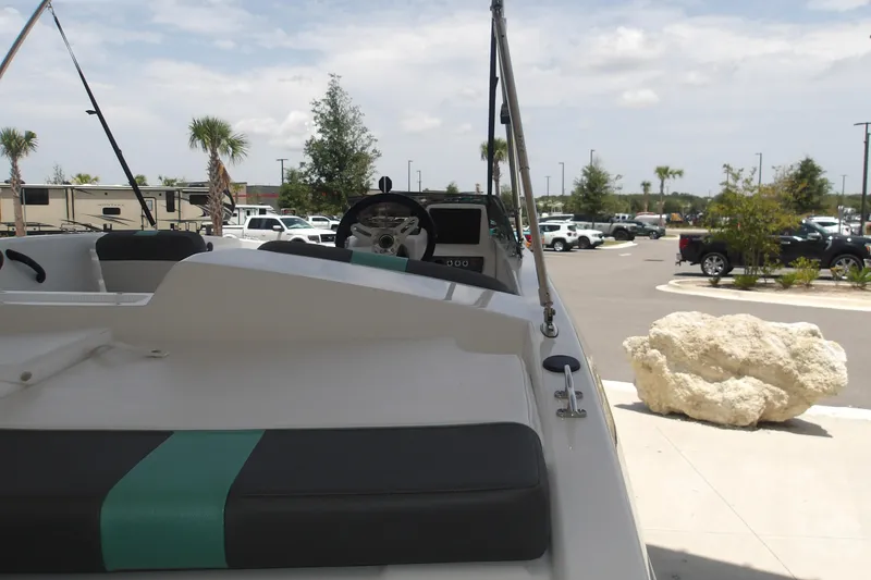Slide: The Image of 2026 Tahoe T18 boat interior with steering wheel, parked outdoors under a cloudy sky. - 7