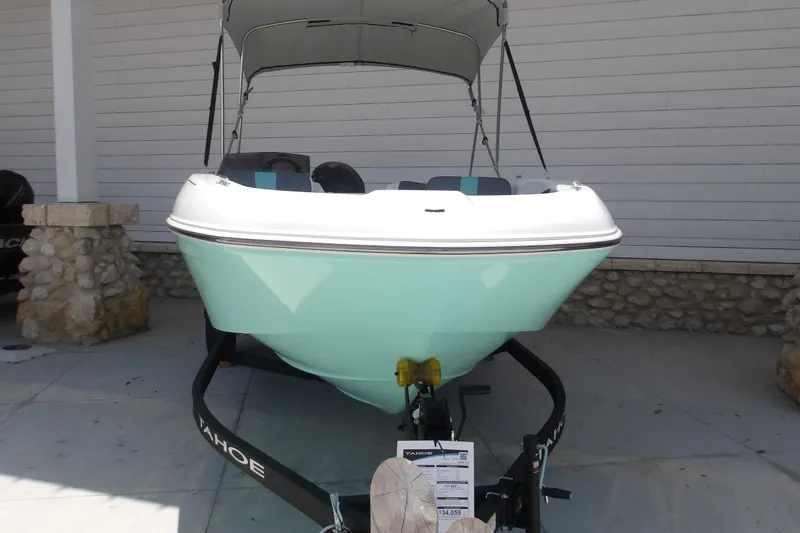 The Image of 2026 Tahoe T18 boat on trailer, displayed outdoors with a canopy. - 1