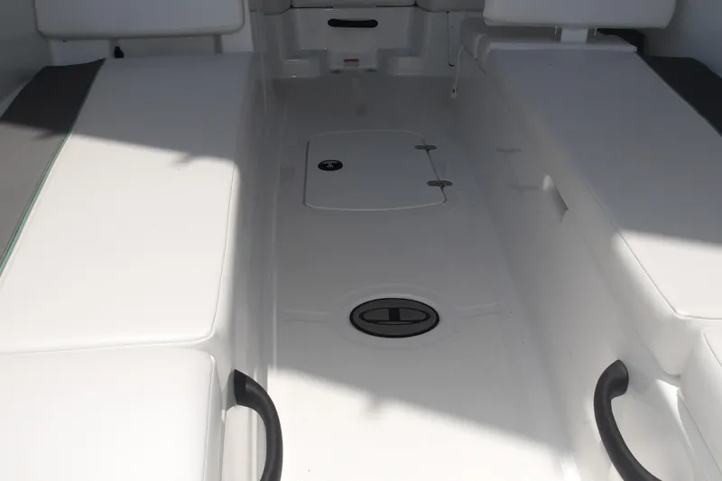 Slide: The Image of Interior view of 2026 Tahoe T18 boat, featuring white seating and storage compartments. - 10