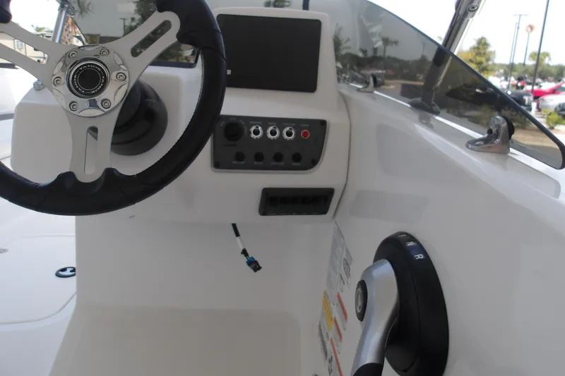 Slide: The Image of 2026 Tahoe T18 boat dashboard with steering wheel and control panel. - 8