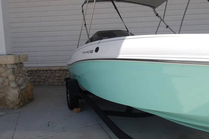 Slide: The Image of 2026 Tahoe T18 boat with a sleek design, parked on a trailer. - 3