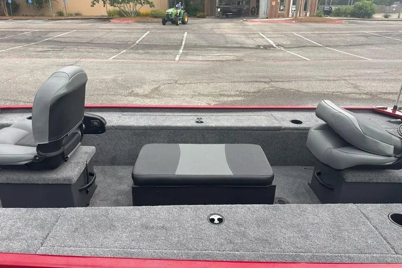 Slide: The Image of 2026 Tracker Panfish 17 boat interior with gray seating in a parking lot. - 5