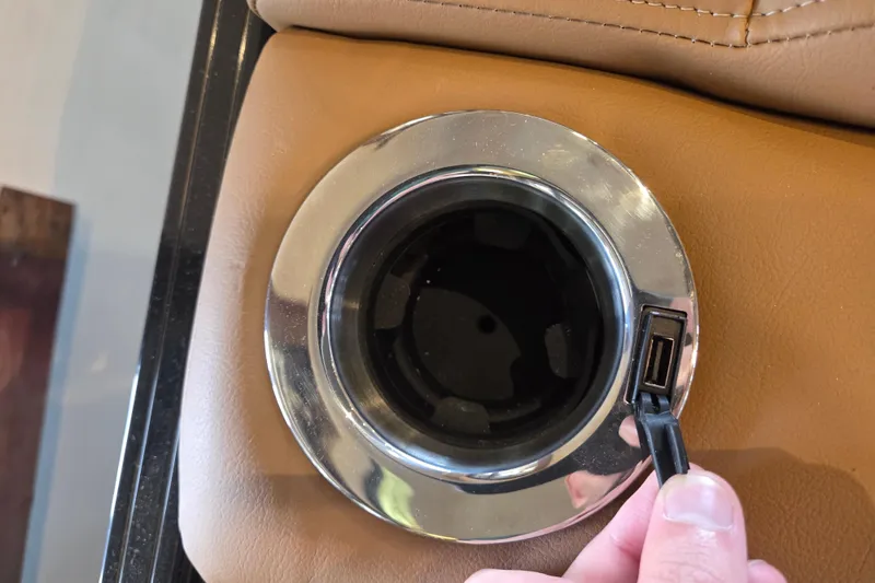 Slide: The Image of USB port and cup holder in 2026 Regency 250 DL boat interior. - 75