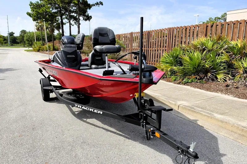 Slide: The Image of 2026 Tracker Pro Team 175 boat on trailer, parked on a sunny street. - 7