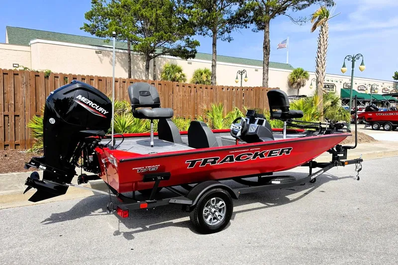 Slide: The Image of 2026 Tracker Pro Team 175 boat with Mercury engine, parked outdoors. - 2