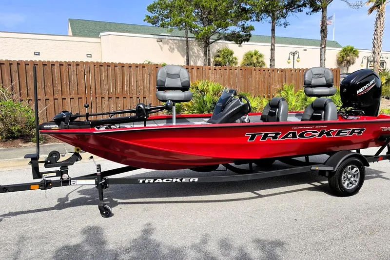 Slide: The Image of 2026 Tracker Pro Team 175 boat in vibrant red on a trailer, parked outdoors. - 10