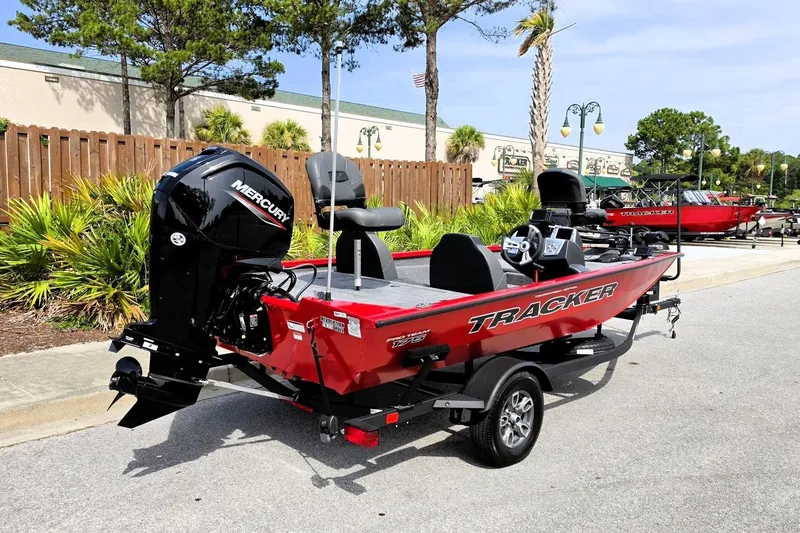 Slide: The Image of 2026 Tracker Pro Team 175 boat with Mercury engine, parked outdoors on a sunny day. - 3