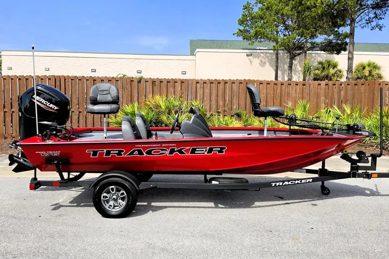 The Image of 2026 Tracker Pro Team 175 boat in vibrant red, parked outdoors on a trailer. - 0