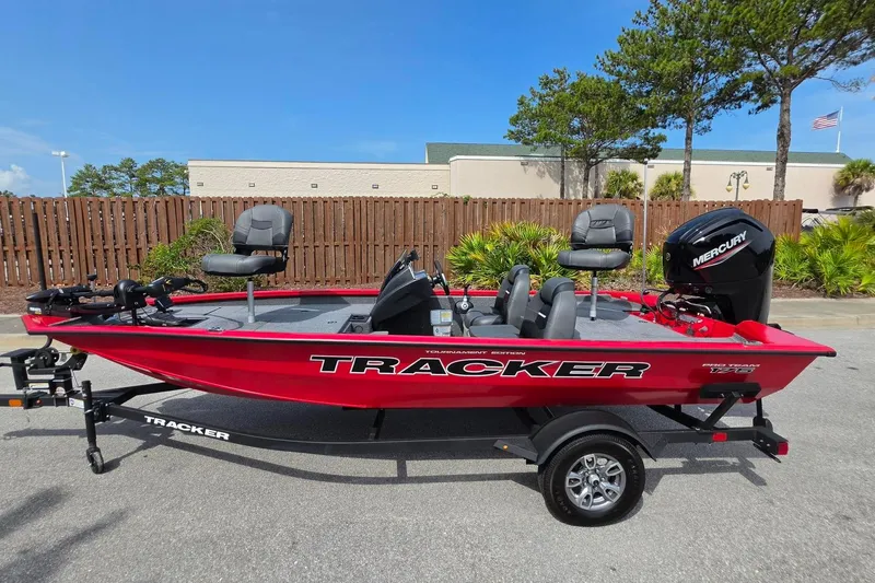Slide: The Image of 2026 Tracker Pro Team 175 boat with Mercury engine, parked outdoors. - 13