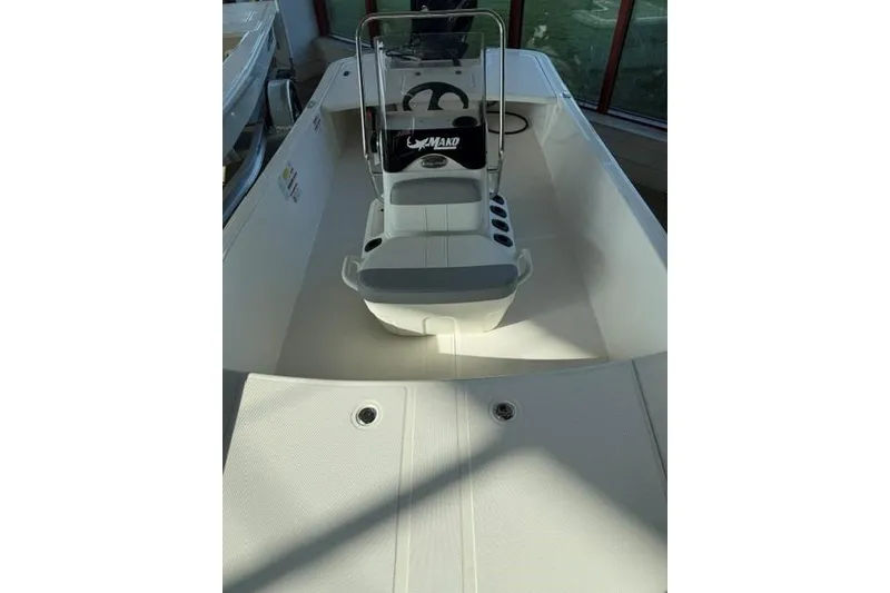 Slide: The Image of 2026 Mako Pro Skiff 17 CC boat interior with steering console and seating. - 5