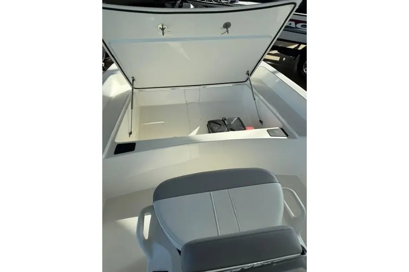 Slide: The Image of 2026 Mako Pro Skiff 17 CC boat with open storage compartment and seating. - 7