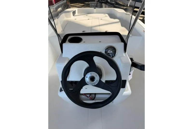 Slide: The Image of 2026 Mako Pro Skiff 17 CC boat console with steering wheel and controls. - 12