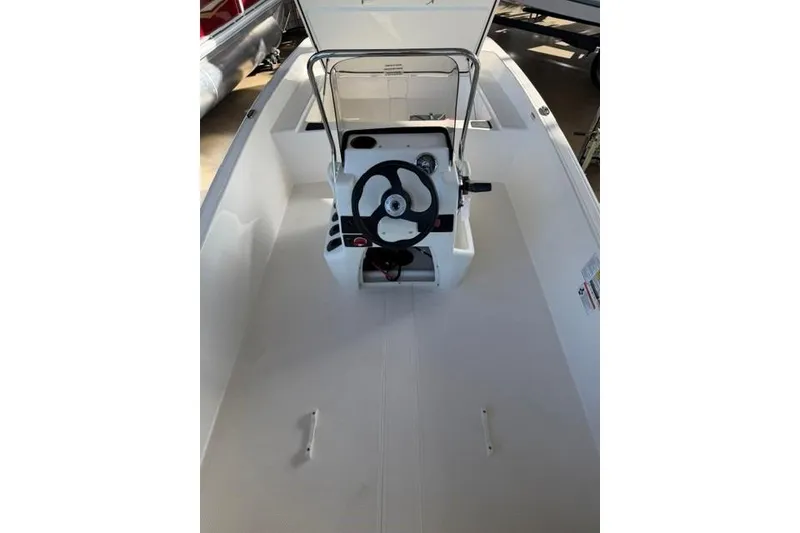 Slide: The Image of 2026 Mako Pro Skiff 17 CC boat interior with steering console and seating. - 9