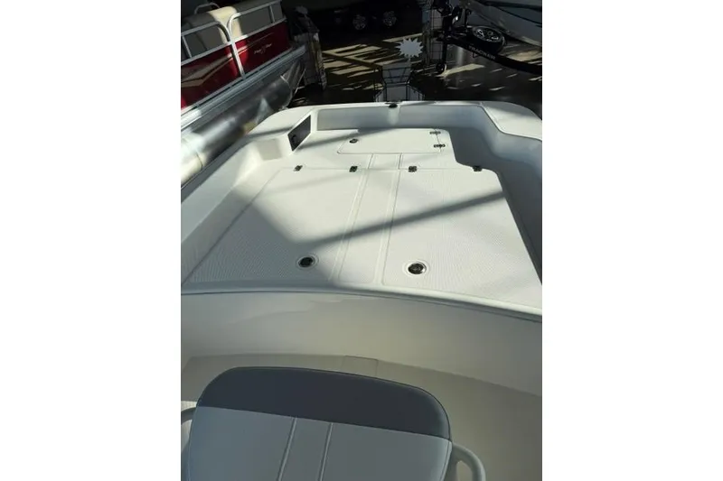 Slide: The Image of 2026 Mako Pro Skiff 17 CC boat interior with seating and storage compartments. - 4