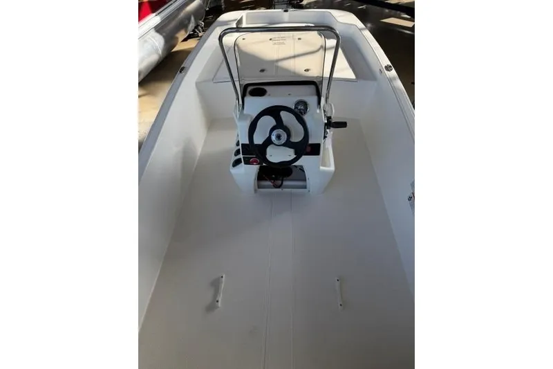 Slide: The Image of 2026 Mako Pro Skiff 17 CC boat interior with steering console. - 11