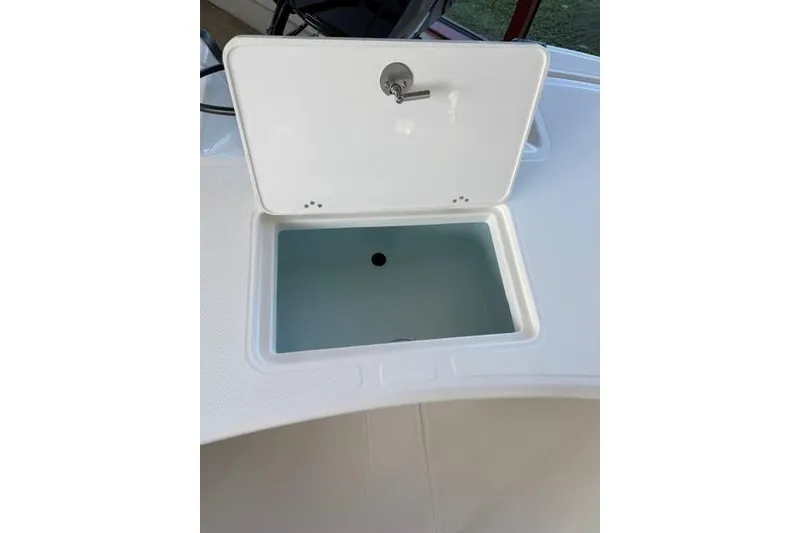 Slide: The Image of Open storage compartment on 2026 Mako Pro Skiff 17 CC boat. - 6