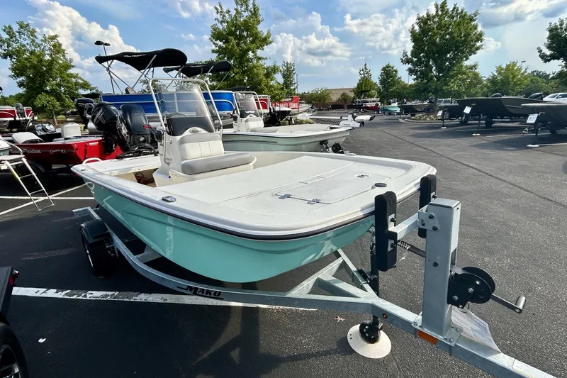 Slide: The Image of 2026 Mako Pro Skiff 13 CC boat on trailer in outdoor showroom. - 3