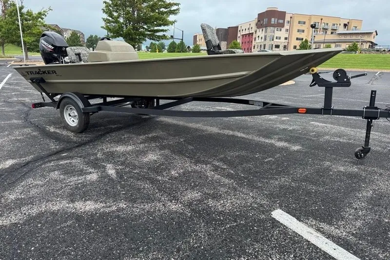 The Image of 2026 Tracker Grizzly 1754 SC boat on trailer in parking lot. - 0