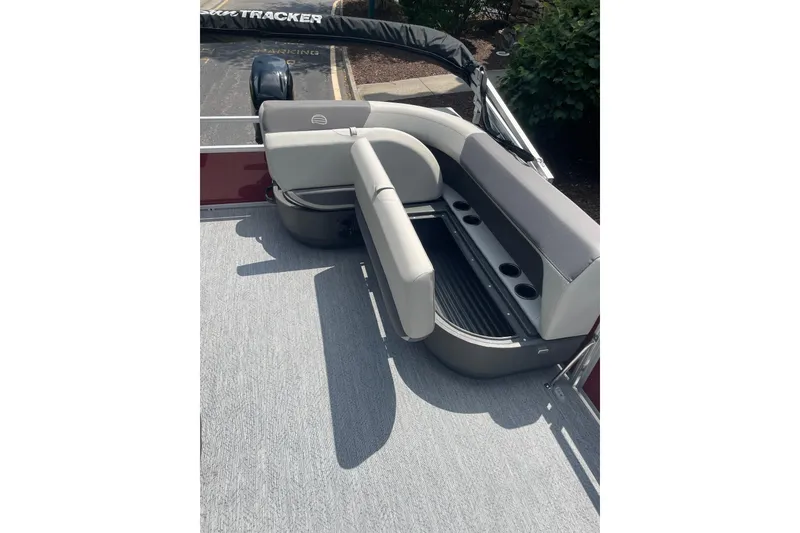 Slide: The Image of 2026 Sun Tracker Bass Buggy 16 XL Select pontoon boat seating area with cup holders. - 6