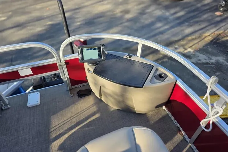Slide: The Image of 2026 Sun Tracker Bass Buggy 16 XL Select boat deck with control panel and seating. - 3