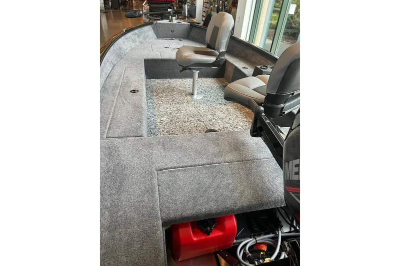 Slide: The Image of 2026 Tracker Super Guide V-16 T boat interior with seating and carpeted deck. - 3