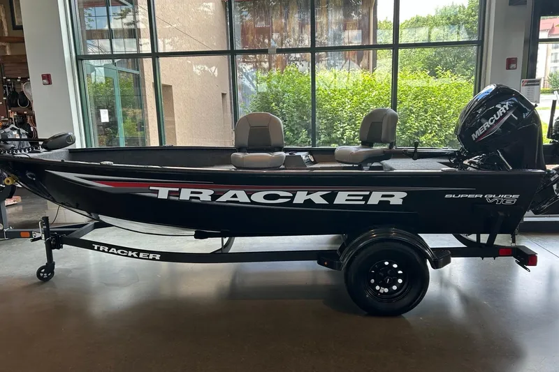 The Image of 2026 Tracker Super Guide V-16 T boat displayed indoors with Mercury engine. - 0