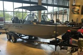 Slide: The Image of 2026 Tracker Targa V-18 Combo boat displayed indoors on a trailer. - 2